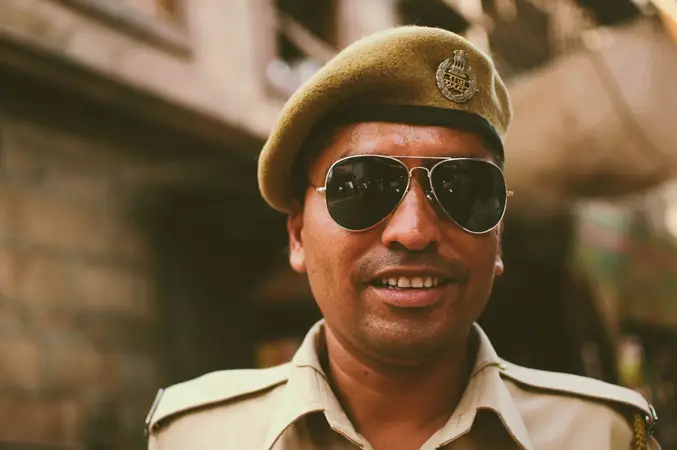 Smiling police officer in a khaki beret and aviator sunglasses on a street