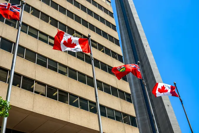 Canadian and Ontario flags flying outside an office building in Toronto