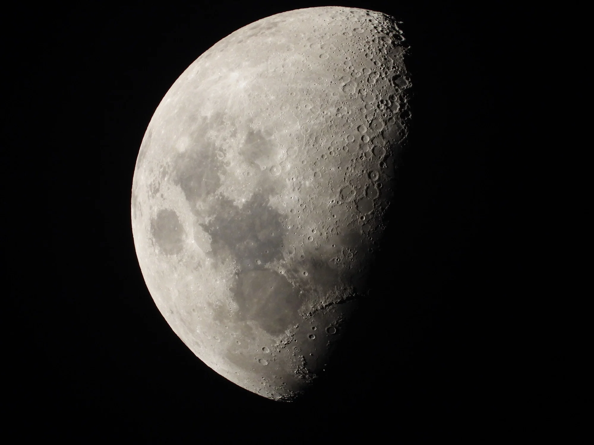 Close view of the Moon's cratered surface at first quarter