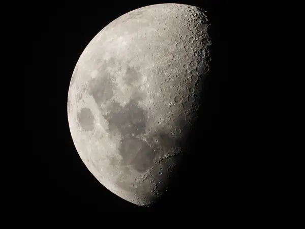 Close view of the Moon's cratered surface at first quarter