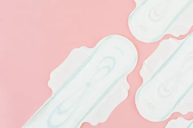 Sanitary pads laid out on a soft pink background