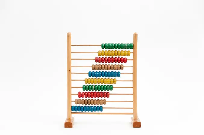 Wooden counting frame with rows of coloured beads, a reminder of place-value counting