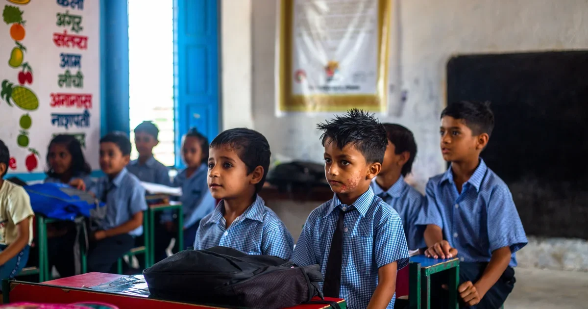 Indian school children in uniform listening attentively in a classroom