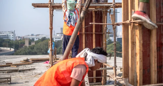A team of construction workers building a high-rise in Delhi, India
