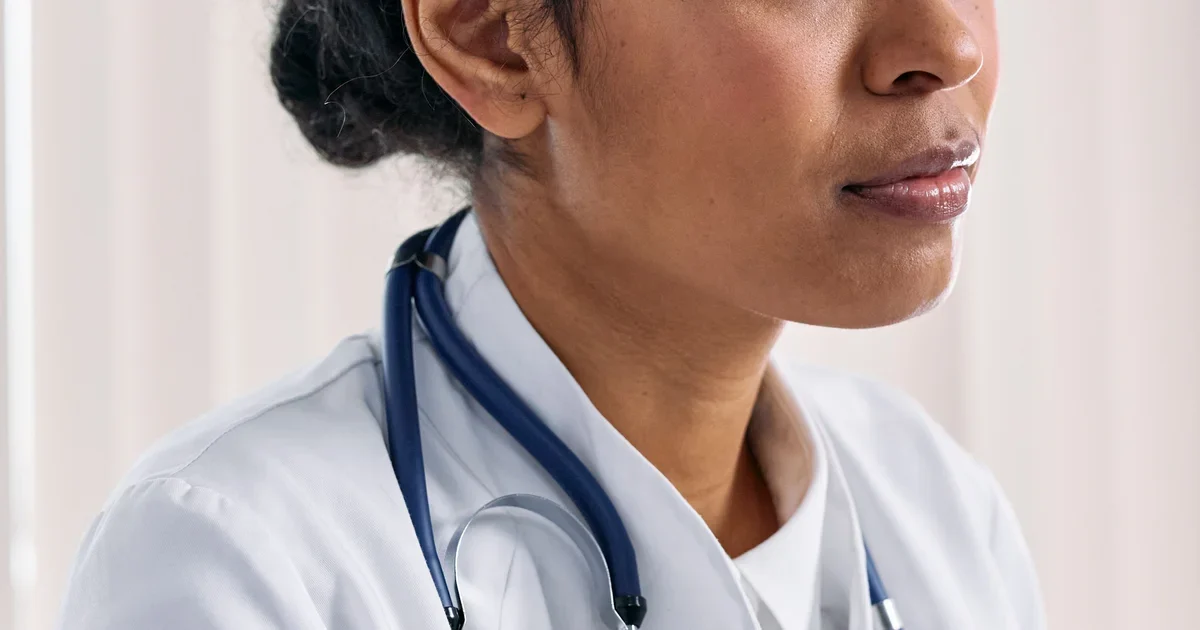 A woman doctor in a white coat with a stethoscope (illustrative image)